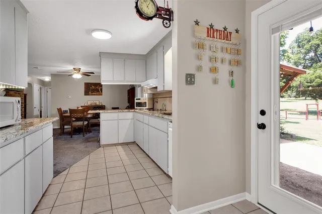 a kitchen with stainless steel appliances a refrigerator sink and microwave