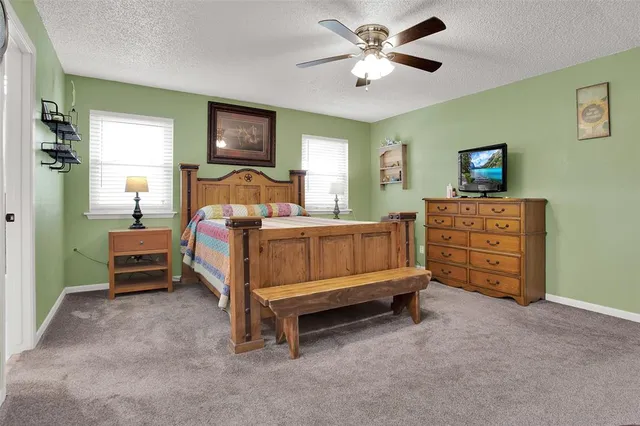 a bedroom with a bed dresser and a window
