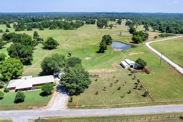 an aerial view of a house with a yard