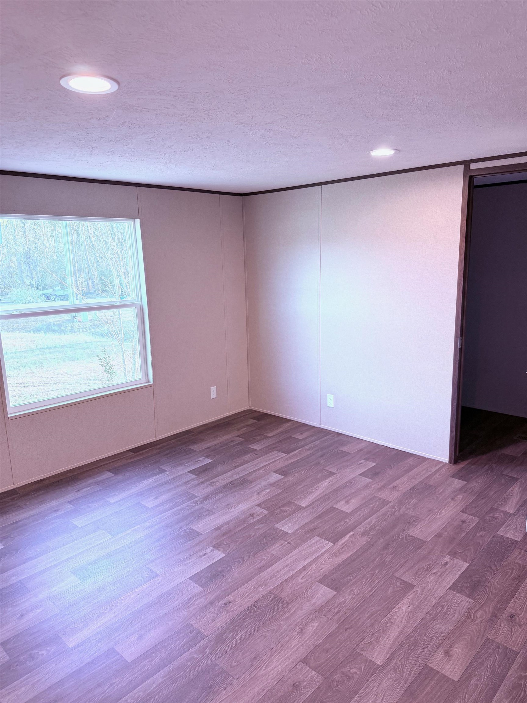 1252 Mallard Court Conway, SC 29526 - Photo 12 of 38 Spare room featuring wood finished floors, a decorative wall, and a textured ceiling