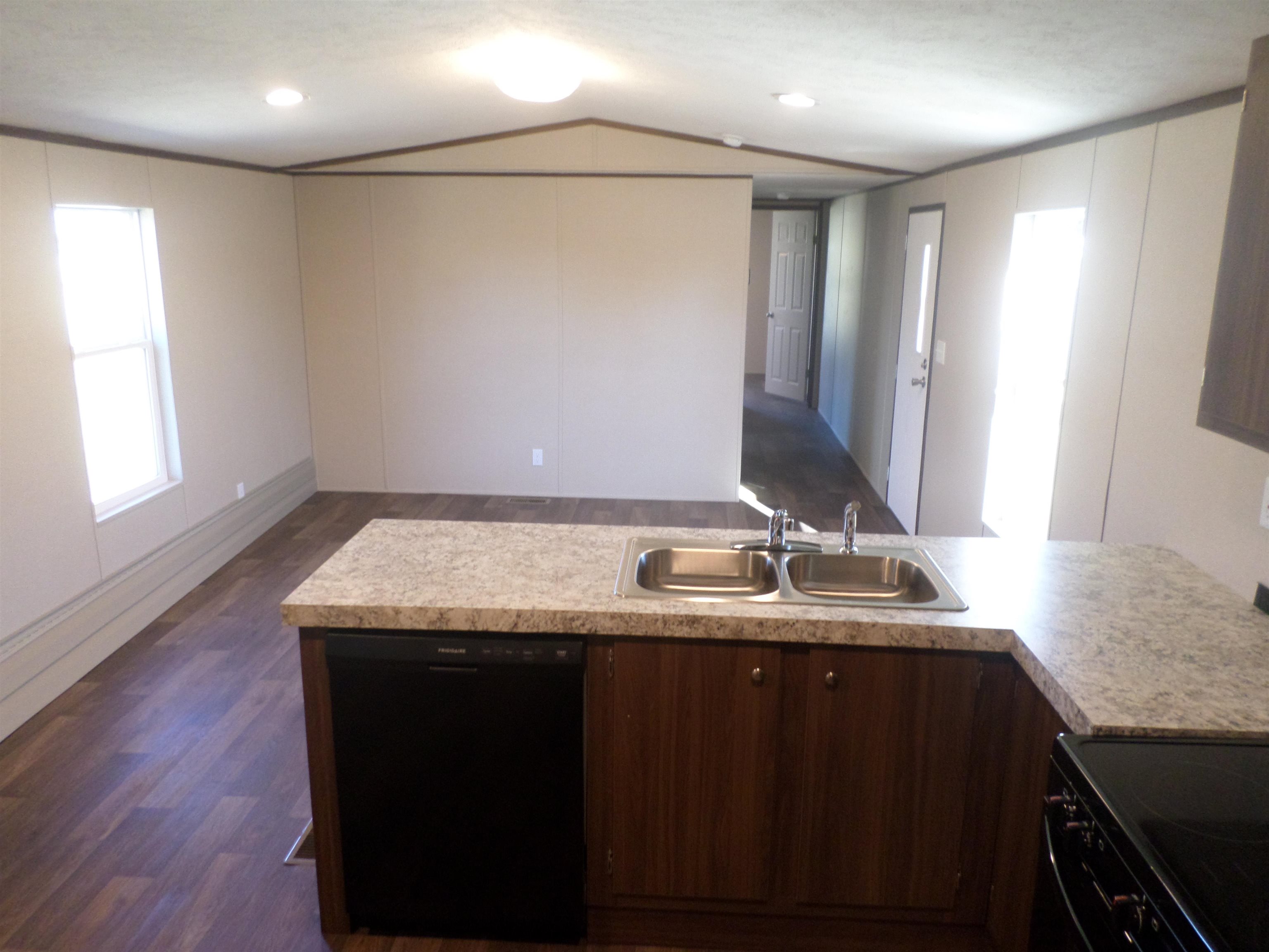 1252 Mallard Court Conway, SC 29526 - Photo 27 of 38 Kitchen with black appliances, dark wood-type flooring, dark brown cabinets, a peninsula, and light countertops