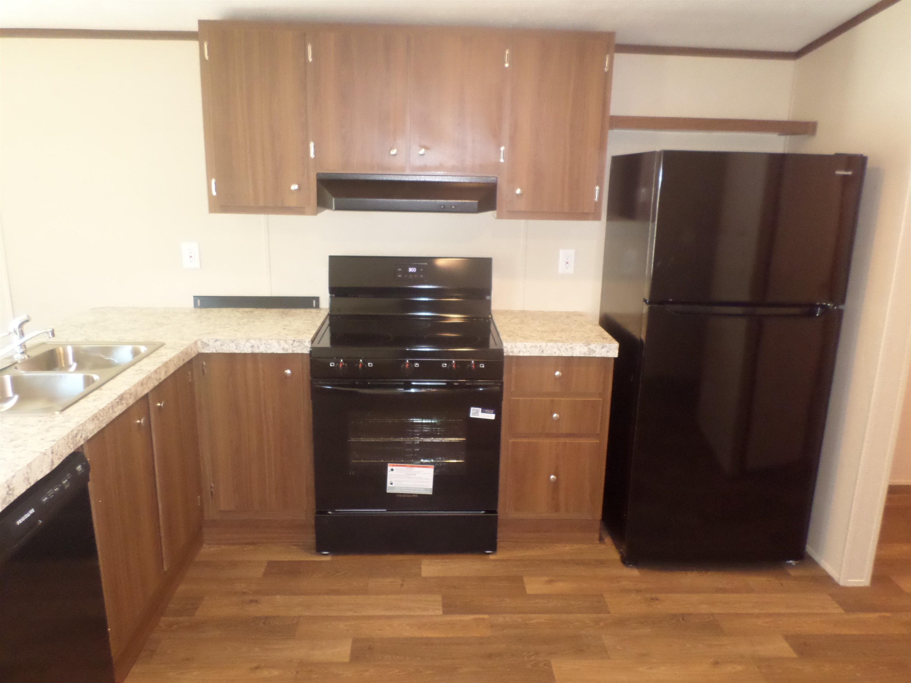 1252 Mallard Court Conway, SC 29526 - Photo 29 of 38 Kitchen featuring black appliances, under cabinet range hood, and light countertops