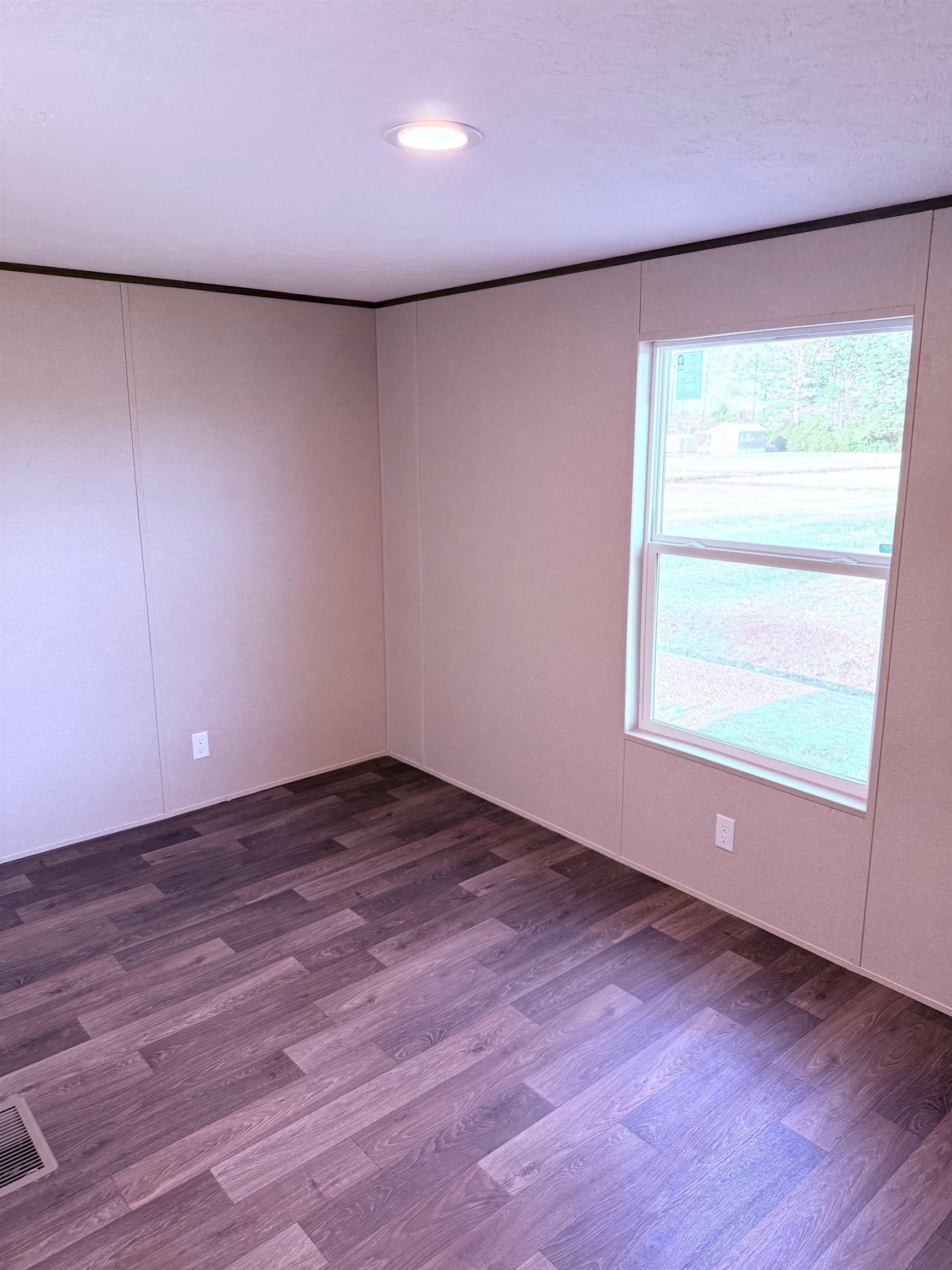 1252 Mallard Court Conway, SC 29526 - Photo 9 of 38 Empty room featuring dark wood-style floors and a decorative wall