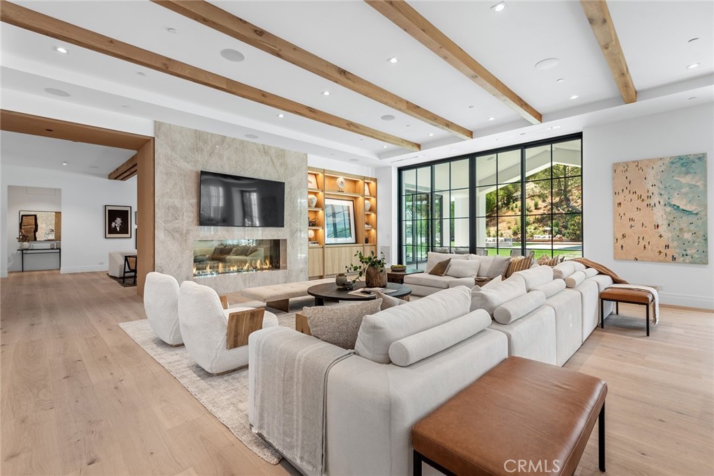 24044 Long Valley Road Hidden Hills, CA 91302 - Photo 13 of 57 a living room with furniture large windows and flat screen tv