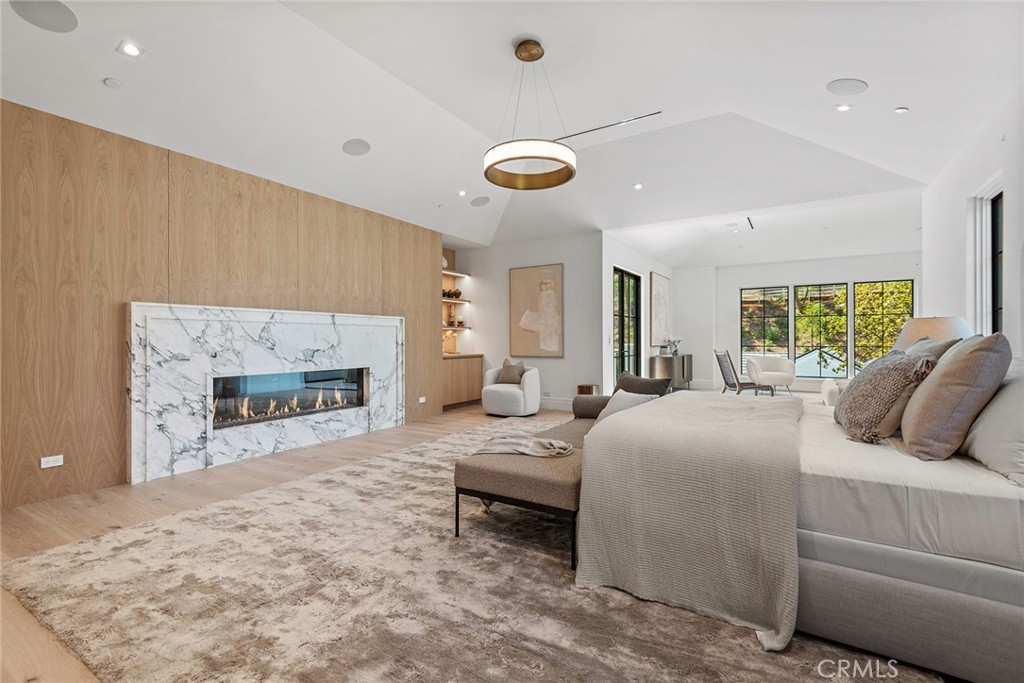 24044 Long Valley Road Hidden Hills, CA 91302 - Photo 25 of 57 a bedroom with a bed and a fireplace