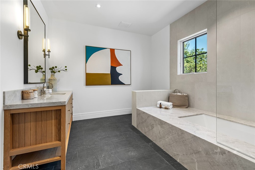 24044 Long Valley Road Hidden Hills, CA 91302 - Photo 34 of 57 a bathroom with a tub sink and mirror
