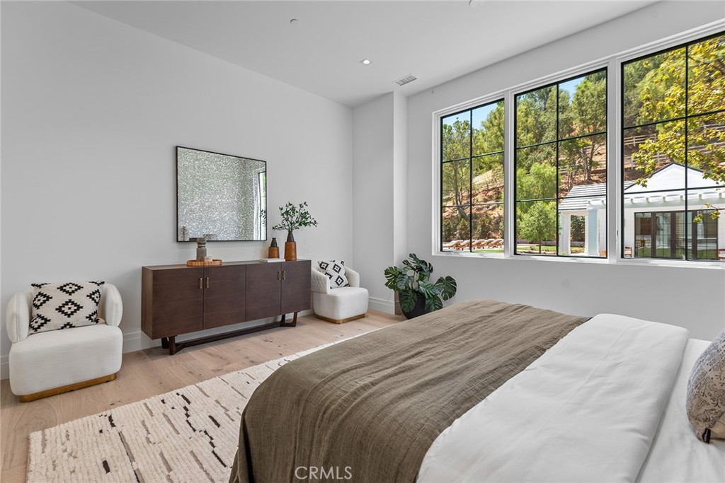 24044 Long Valley Road Hidden Hills, CA 91302 - Photo 41 of 57 a bedroom with a large bed and a large window