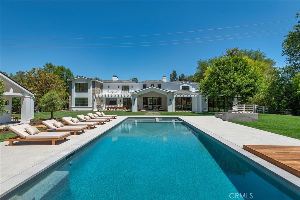 24044 Long Valley Road Hidden Hills, CA 91302 - Photo 48 of 57 a view of a house with pool and chairs