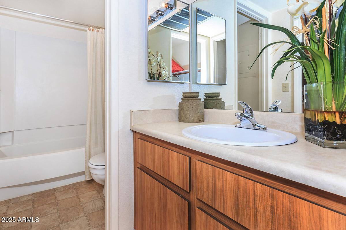 3040 East Shea Boulevard Phoenix, AZ 85028 - Photo 5 of 11 a bathroom with a sink and a mirror
