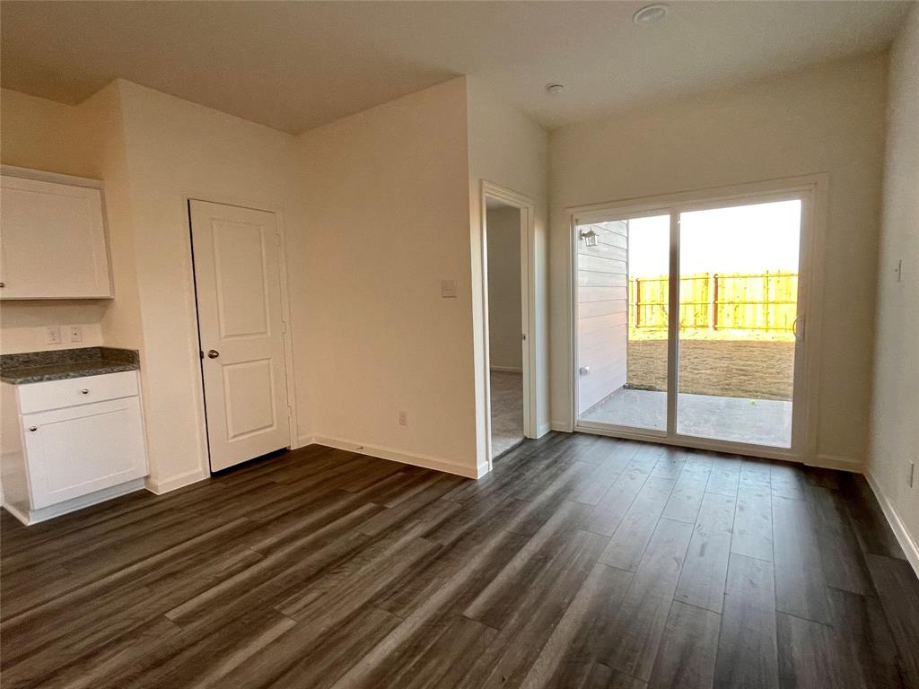 6222 Old Bridge Way Forney, TX 75126 - Photo 4 of 17 an empty room with wooden floor and windows