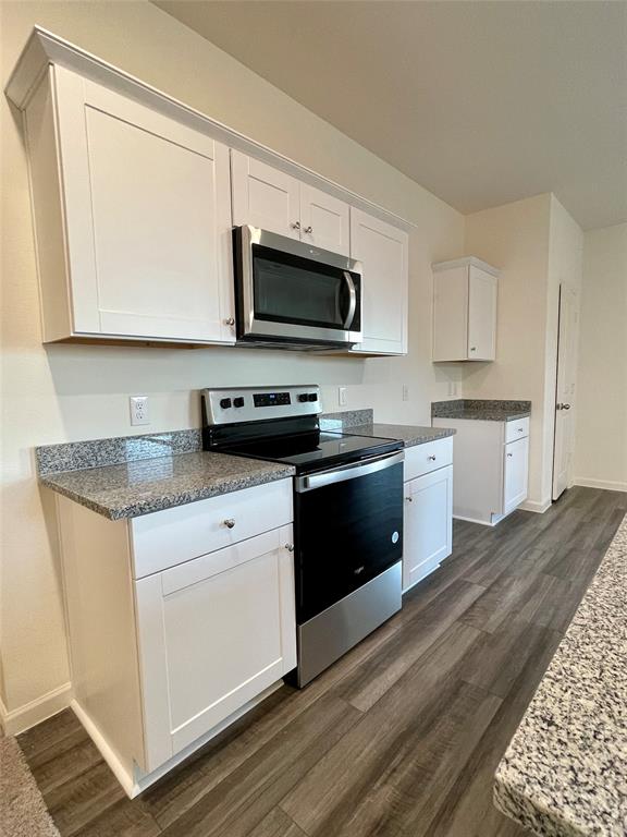 6222 Old Bridge Way Forney, TX 75126 - Photo 5 of 17 a kitchen with stainless steel appliances granite countertop a sink a stove a microwave and cabinets
