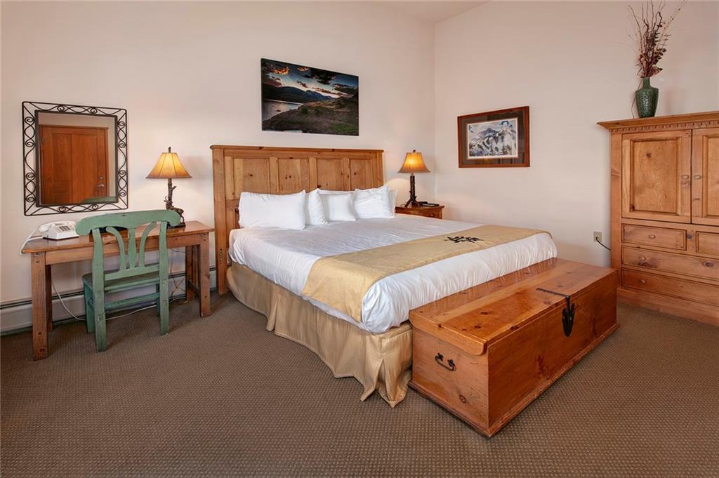 195 River Run Road, Unit 8017 Keystone, CO 80435 - Photo 14 of 32 a bed room with a bed and a chair