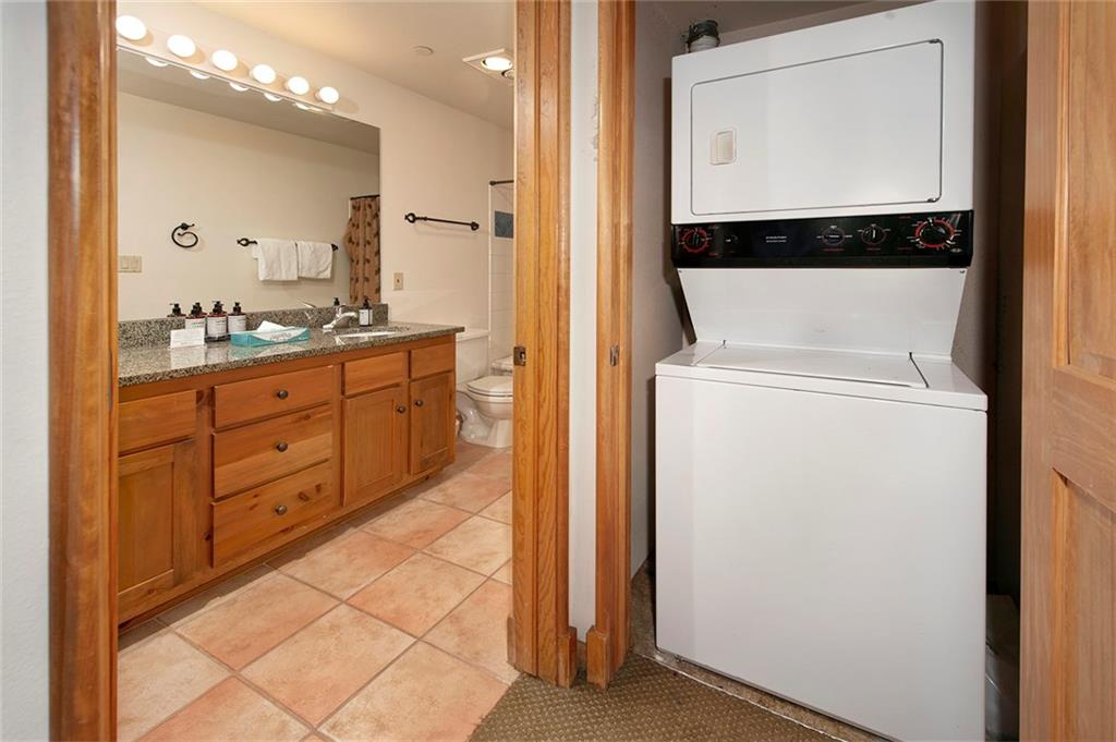 195 River Run Road, Unit 8017 Keystone, CO 80435 - Photo 16 of 32 a view of a hallway with washer and dryer