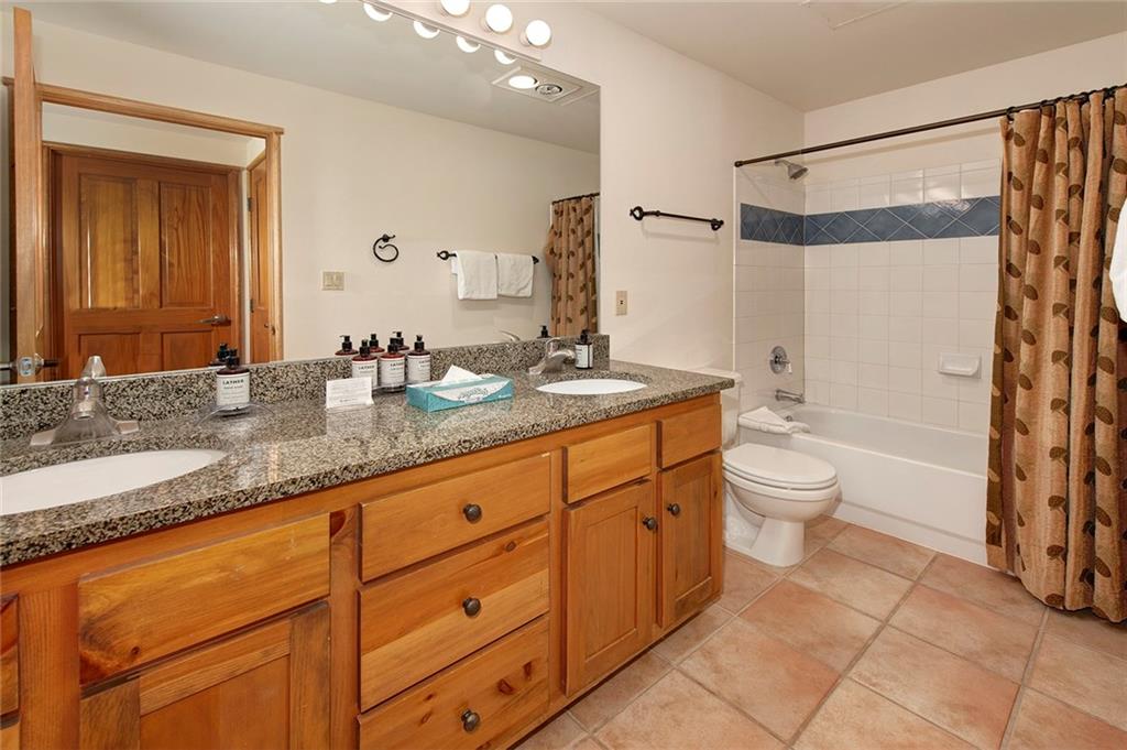 195 River Run Road, Unit 8017 Keystone, CO 80435 - Photo 17 of 32 a bathroom with a granite countertop sink toilet and shower
