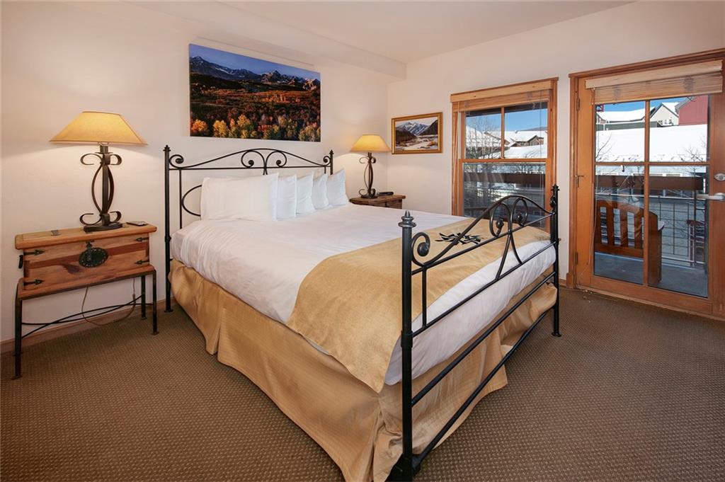 195 River Run Road, Unit 8017 Keystone, CO 80435 - Photo 18 of 32 a bedroom with a bed and a lamp next to a window