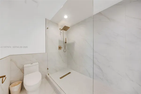 a bathroom with a toilet and a shower