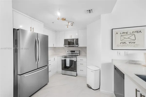 a kitchen with a refrigerator sink and stove