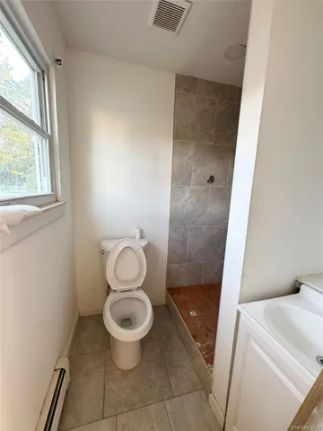 a bathroom with a toilet and a shower