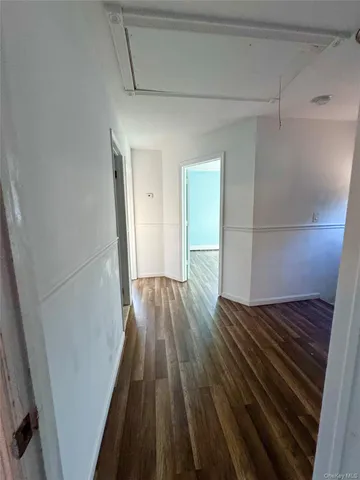 a view of a room with wooden floor and staircase