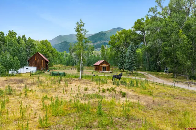 a swimming pool with trees in the background