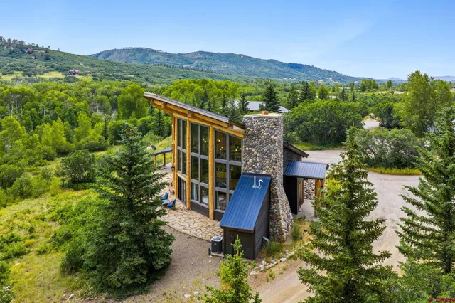 an aerial view of residential house with outdoor space and mountain view
