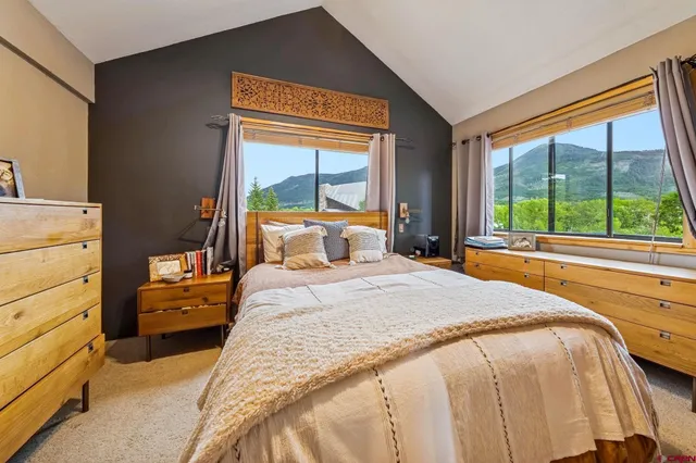 a bedroom with a bed and a large window