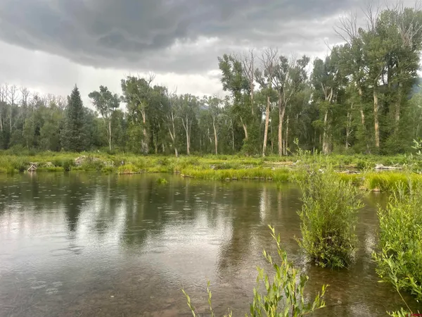 a view of a lake with a yard