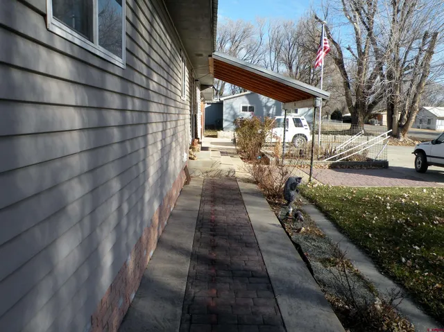 a view of a pathway with a backyard