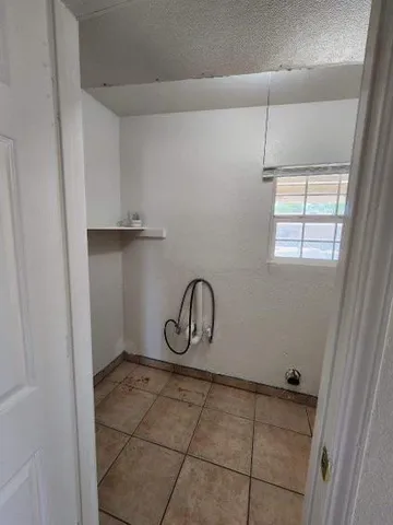 a bathroom with a granite countertop sink a window and vanity