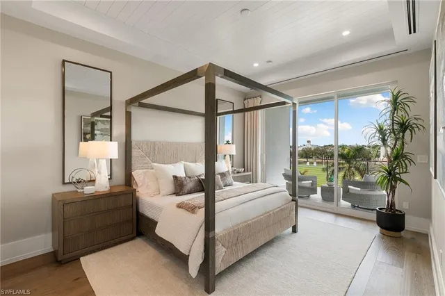 a bedroom with a bed and glass windows