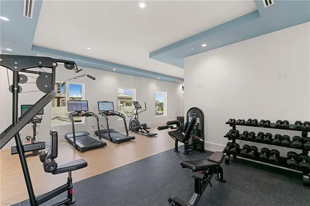 a room with gym equipment and a flat screen tv