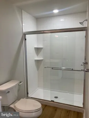 a bathroom with a toilet and a shower