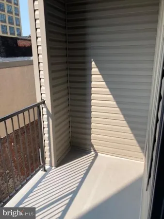 a view of a balcony with wooden floor and staircase