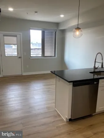a kitchen with wooden floors and window
