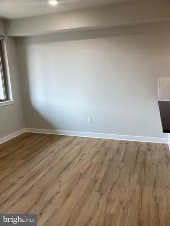 a view of an empty room and wooden floor