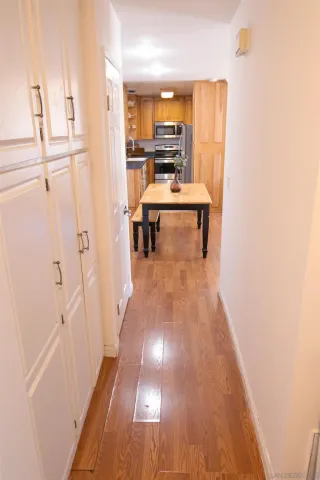 a view of a hallway with wooden floor