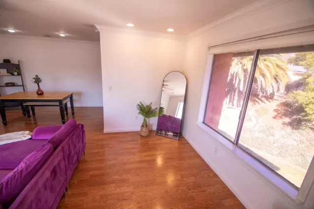 a living room with furniture fireplace and a large window