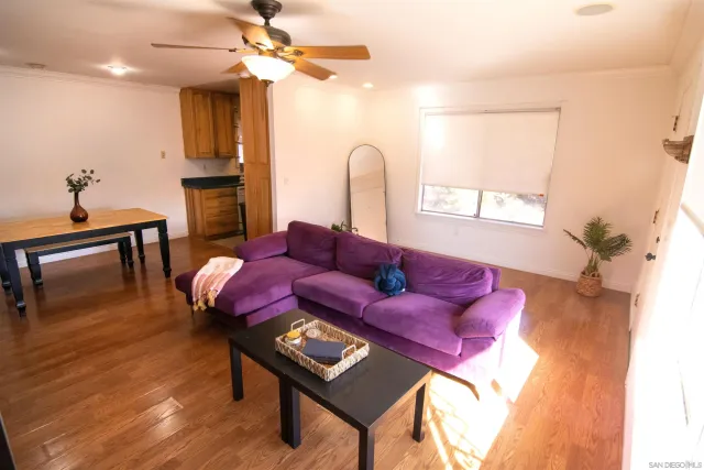 a living room with furniture a window and a chandelier