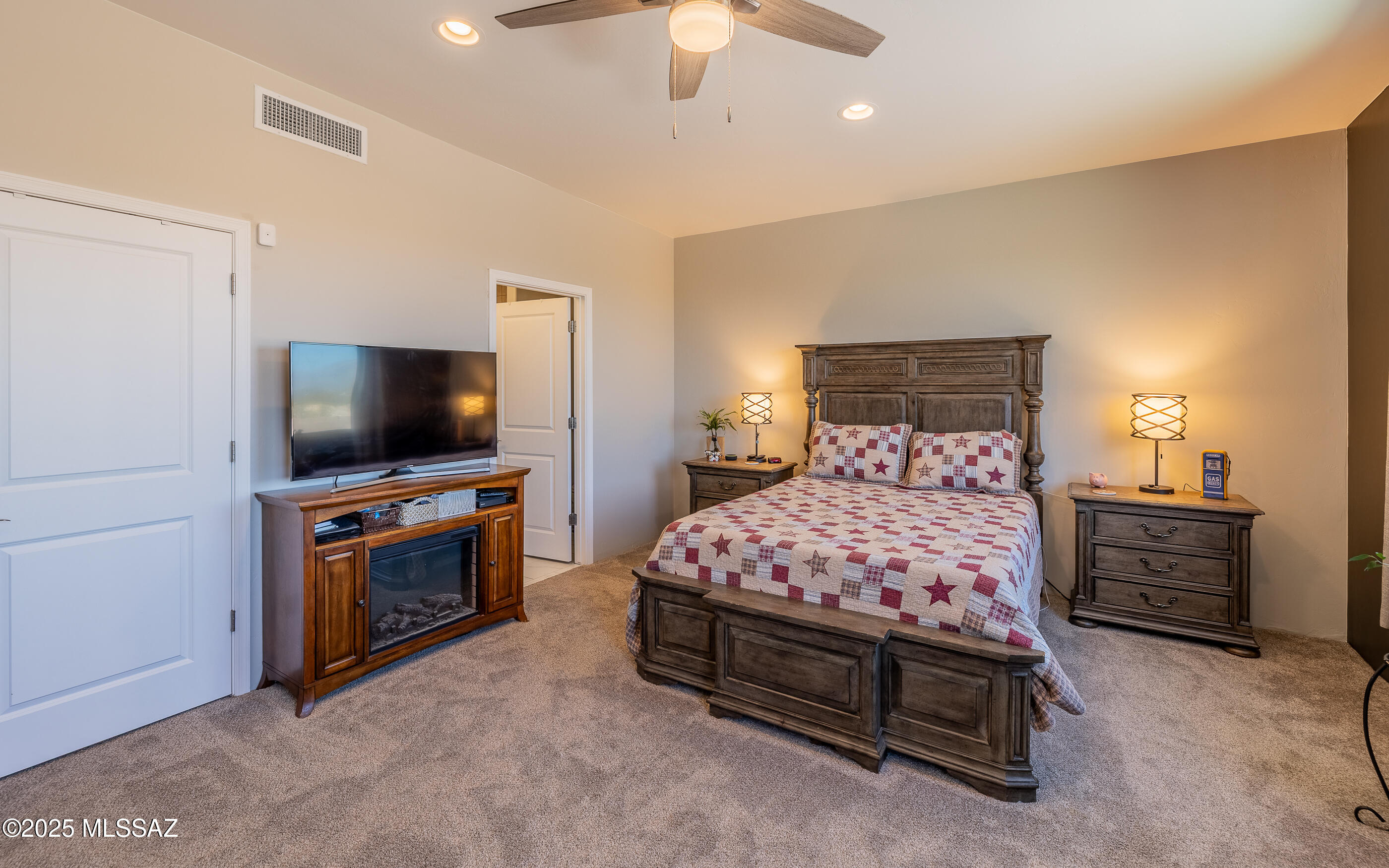 12123 Creosote Valley Road Vail, AZ 85641 - Photo 24 of 46 a bedroom with furniture and flat screen tv