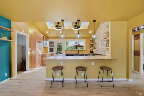 a large kitchen with a table and chairs