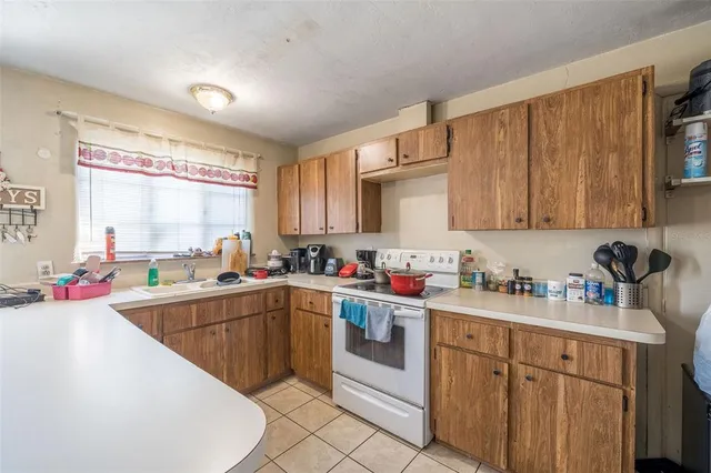 a kitchen with a sink cabinets and window