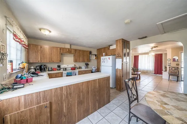 a kitchen with stainless steel appliances lots of counter top space and furniture