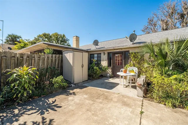 a view of a chair and table in the backyard
