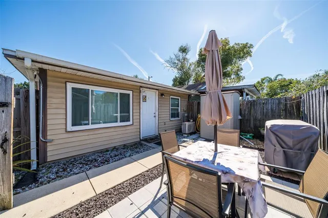 a view of a house with backyard and sitting area