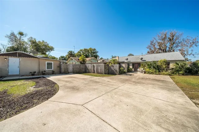 a view of a patio with a table and chairs under an umbrella