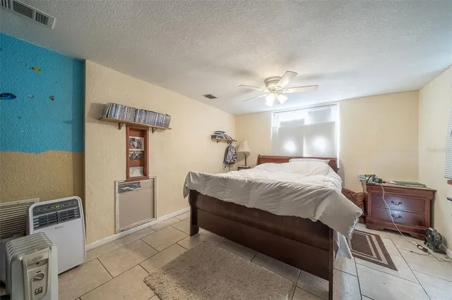 a bedroom with a bed and cabinets