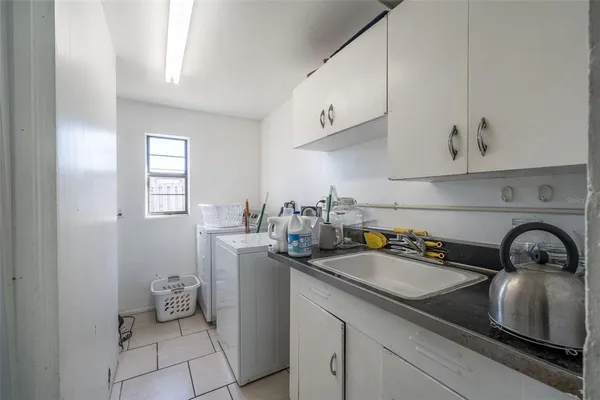 a kitchen with a sink and cabinets