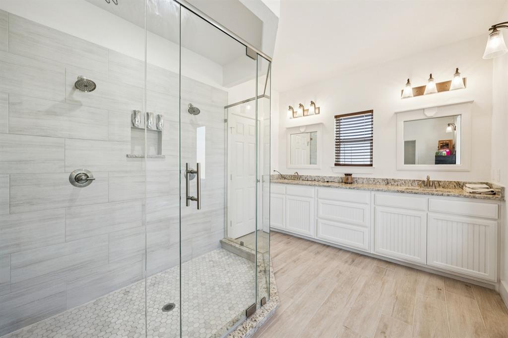 1084 Justin Drive Springtown, TX 76082 - Photo 15 of 28 a spacious bathroom with a granite countertop sink mirror and shower