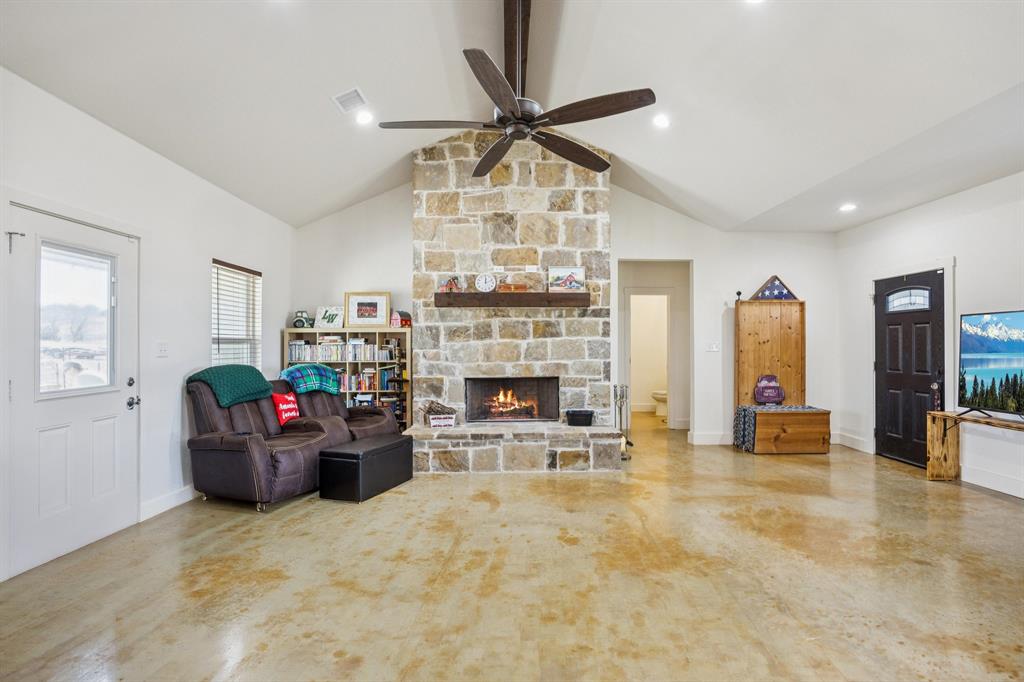 1084 Justin Drive Springtown, TX 76082 - Photo 3 of 28 a living room with furniture a fireplace and a chandelier