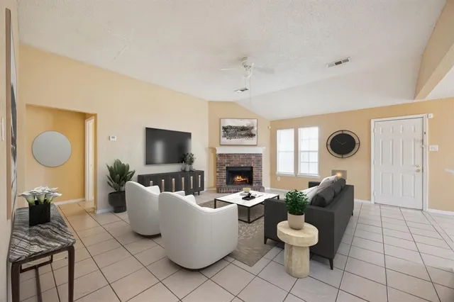 a living room with furniture a fireplace and a flat screen tv